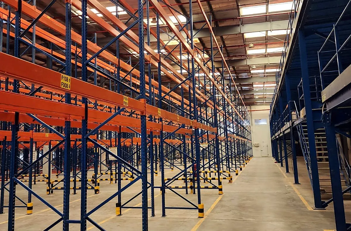 High bay heavy duty pallet racking with blue frames and orange beams in a UAE warehouse